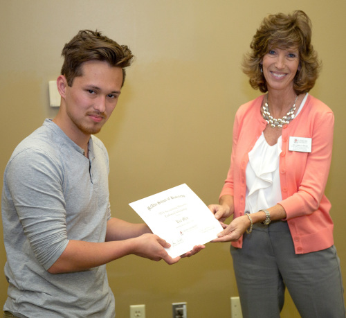 Karen Miller (right) presents a scholarship from Alexander Thompson Arnold PLLC to Kia Min (left). (Photo by Scott Goff)